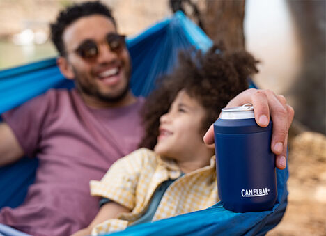 Father in a hammock with his son and a CamelBak Can Cooler